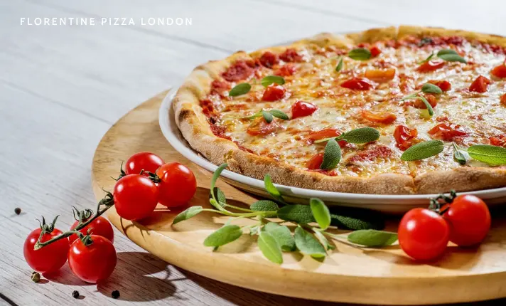 A freshly baked Florentine pizza with a golden crust, topped with spinach, creamy mozzarella, and a soft egg in the center, served on a wooden table in Covent Garden, London.